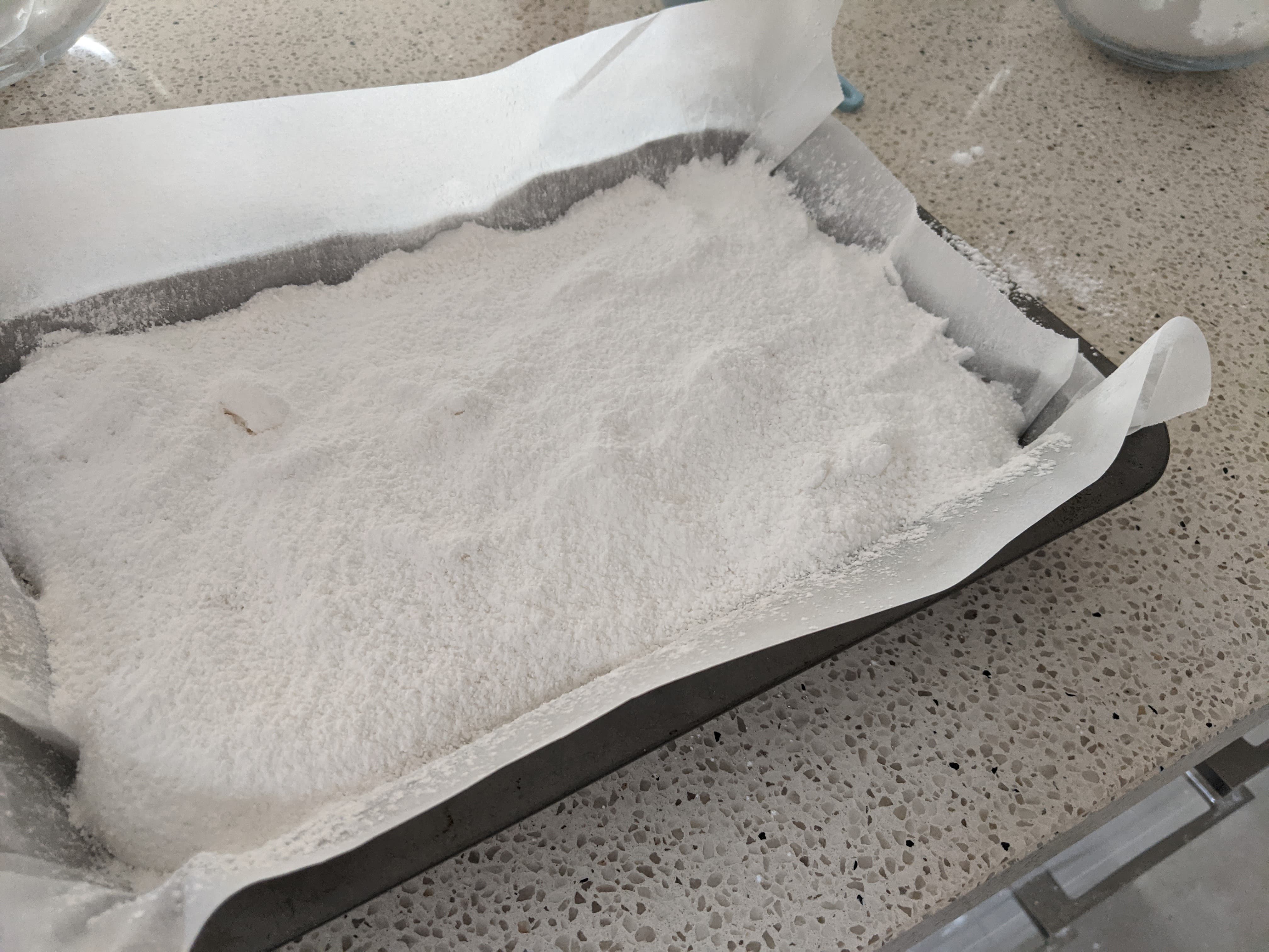 A pan with marshmallow dusted with icing sugar and cornflour