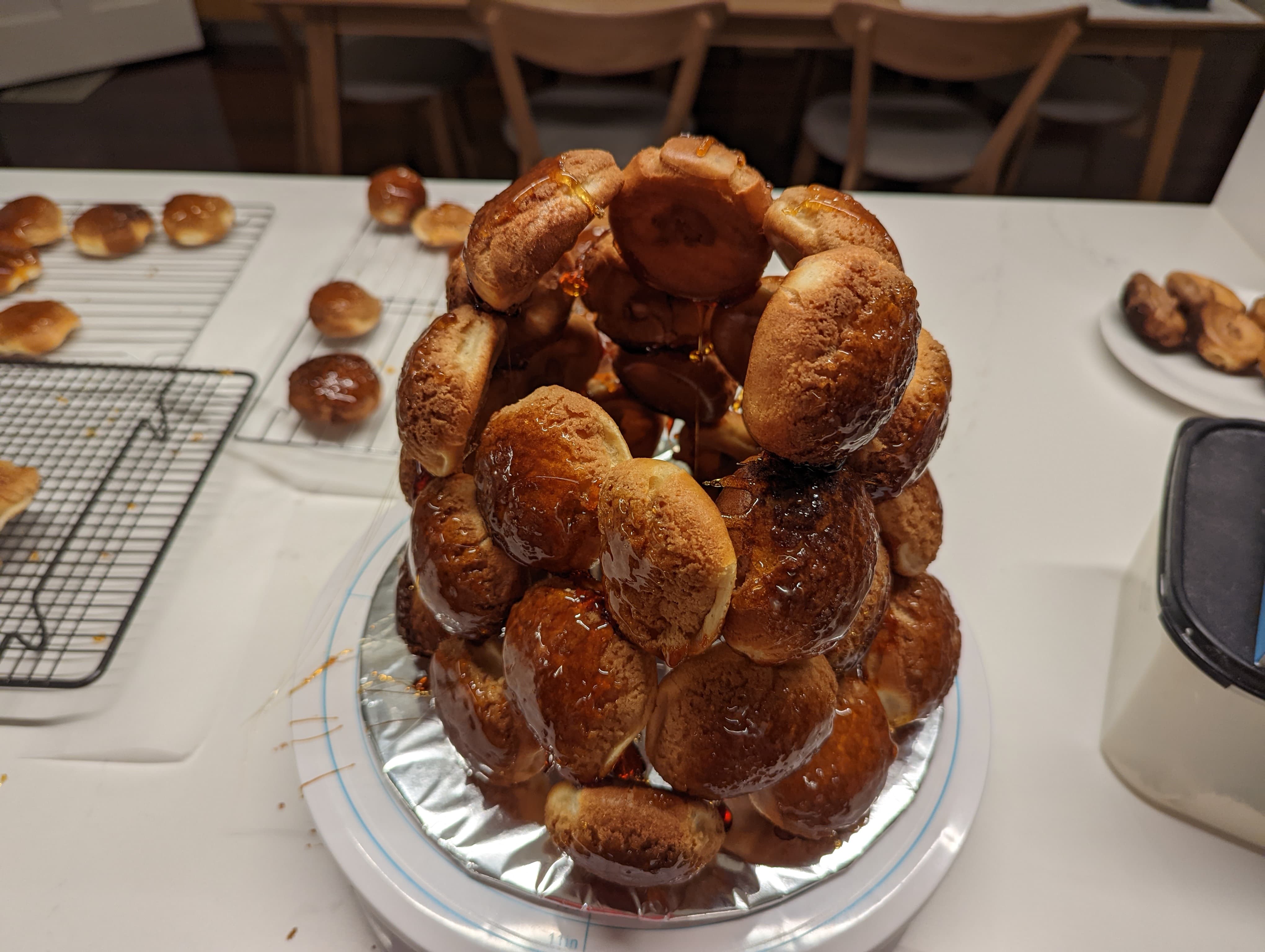 A half-built tower of choux pastries, stuck together with caramelized sugar